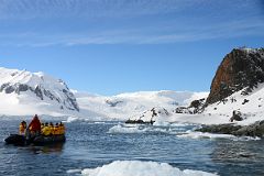 12A Zodiac Travels Around The Lichen Clad Cliffs Of Cuverville Island With Small Mountains And Glaciers On Antarctica On Quark Expeditions Antarctica Cruise.jpg